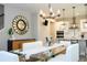 Modern dining area with glass table, stylish decor, and adjacent kitchen at 12259 Bracco St, Winter Garden, FL 34787