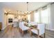 Open dining area featuring a modern table and chairs with the kitchen visible, bathed in natural light at 12259 Bracco St, Winter Garden, FL 34787