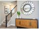 Welcoming entryway featuring stylish console table, decorative mirror, and staircase with modern railing at 12259 Bracco St, Winter Garden, FL 34787