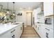 Bright, open concept kitchen with white cabinets, stainless steel appliances, island, and pendant lighting at 12259 Bracco St, Winter Garden, FL 34787