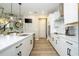 Modern kitchen with stainless appliances, white cabinets, an island with a dishwasher, and pendant lights at 12259 Bracco St, Winter Garden, FL 34787