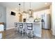 Modern kitchen with white cabinetry, stainless steel appliances, a center island and stylish pendant lighting at 12259 Bracco St, Winter Garden, FL 34787