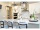 Bright kitchen featuring quartz countertops, modern appliances, and a breakfast bar with pendant lighting at 12259 Bracco St, Winter Garden, FL 34787