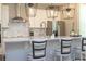 Modern kitchen with stainless steel appliances, white cabinetry, quartz countertops, and stylish pendant lighting at 12259 Bracco St, Winter Garden, FL 34787