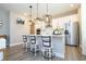Modern kitchen with white cabinetry, stainless steel appliances, a center island and stylish pendant lighting at 12259 Bracco St, Winter Garden, FL 34787