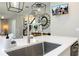 Modern kitchen sink with spring faucet, quartz counters and a view of the staircase at 12259 Bracco St, Winter Garden, FL 34787