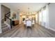 Open-concept living area with dining table, kitchen, staircase and modern finishes and abundant natural light at 12259 Bracco St, Winter Garden, FL 34787