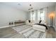 Bright living room with a cozy couch, modern lighting, and large windows at 12259 Bracco St, Winter Garden, FL 34787