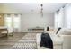 Spacious living room with modern decor, a plush sofa, and ample natural light at 12259 Bracco St, Winter Garden, FL 34787
