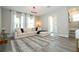 Bright living room featuring a large sectional sofa, stylish rug, and abundant natural light from large windows at 12259 Bracco St, Winter Garden, FL 34787