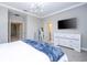Bright main bedroom featuring a stylish light fixture, ensuite bathroom, and spacious closet at 12259 Bracco St, Winter Garden, FL 34787