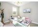 Home office featuring a glass desk, mounted TV, and window views at 12259 Bracco St, Winter Garden, FL 34787