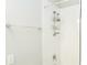 Shower with white tile, chrome fixtures, and convenient storage at 12259 Bracco St, Winter Garden, FL 34787