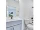 Bathroom featuring gray vanity, white subway tile, and a view of the outdoors through a window at 13075 Sunrise Harvest Dr, Winter Garden, FL 34787