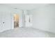Bedroom featuring plush gray carpet, neutral color palette, and two doors one leading to a bathroom at 13075 Sunrise Harvest Dr, Winter Garden, FL 34787