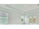 Primary bedroom boasts a tray ceiling, and large windows providing natural light at 13075 Sunrise Harvest Dr, Winter Garden, FL 34787