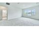 Bedroom featuring plush gray carpet, a neutral color palette, and natural light from the three windows at 13075 Sunrise Harvest Dr, Winter Garden, FL 34787