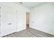 Bedroom featuring wood-look flooring and a closet space with double doors at 13075 Sunrise Harvest Dr, Winter Garden, FL 34787