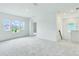 Spacious bonus room featuring three windows, plush carpeting, and bright natural light at 13075 Sunrise Harvest Dr, Winter Garden, FL 34787