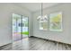 Bright dining room with hardwood floors and a sliding glass door that leads to a brick patio at 13075 Sunrise Harvest Dr, Winter Garden, FL 34787