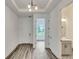 Bright entryway showcasing wood-look floors, modern lighting, and access to various rooms, with a half bath visible at 13075 Sunrise Harvest Dr, Winter Garden, FL 34787