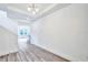 Entryway featuring wood-look flooring, modern lighting, and an open-concept design at 13075 Sunrise Harvest Dr, Winter Garden, FL 34787