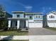 Charming two-story home featuring a two-car garage and a beautifully landscaped front yard under a bright sky at 13075 Sunrise Harvest Dr, Winter Garden, FL 34787