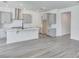 Modern kitchen featuring gray cabinets, a center island, stainless steel appliances, and stylish tile backsplash at 13075 Sunrise Harvest Dr, Winter Garden, FL 34787