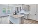 This kitchen features an island with light countertops, gray cabinets, and stainless steel appliances at 13075 Sunrise Harvest Dr, Winter Garden, FL 34787