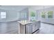 The kitchen island features a stainless steel dishwasher and light countertops at 13075 Sunrise Harvest Dr, Winter Garden, FL 34787