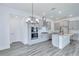 Modern kitchen boasts gray cabinets, stainless steel appliances, and a center island with stylish countertops at 13075 Sunrise Harvest Dr, Winter Garden, FL 34787