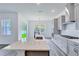 Bright kitchen with stainless steel appliances, light countertops, gray cabinets, and an island with a sink at 13075 Sunrise Harvest Dr, Winter Garden, FL 34787