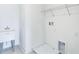 Bright laundry room with a utility sink, wire shelving, and hookups for washer and dryer at 13075 Sunrise Harvest Dr, Winter Garden, FL 34787