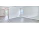 Bright living space with gray wood-look floors, ample lighting, and open access to the entryway at 13075 Sunrise Harvest Dr, Winter Garden, FL 34787