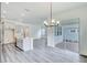 Modern open-concept design featuring a kitchen island, dining area, and sliding glass doors, offering a bright and spacious layout at 13075 Sunrise Harvest Dr, Winter Garden, FL 34787