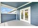 Covered patio features blue siding and a view of the blue skies at 13075 Sunrise Harvest Dr, Winter Garden, FL 34787