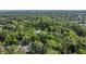 Aerial view of a lush, wooded landscape with a pond and water feature at 1315 E 24Th St, Sanford, FL 32771