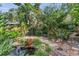 Beautiful backyard with a stone-lined pond and lush garden at 1315 E 24Th St, Sanford, FL 32771