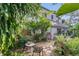 Lush backyard garden with stone pathway, seating, and mature trees at 1315 E 24Th St, Sanford, FL 32771