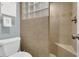 Stylish bathroom featuring tiled shower with glass accents, toilet, and a towel storage unit at 1315 E 24Th St, Sanford, FL 32771