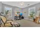 Bright bedroom area with white ceiling fan, neutral carpet, and two windows at 1315 E 24Th St, Sanford, FL 32771
