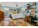 Bright bedroom featuring a comfortable bed, warm lighting, charming decor, and an adjacent study area at 1315 E 24Th St, Sanford, FL 32771