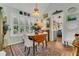 Charming dining room with hardwood floors, light fixture, and a view into the kitchen area at 1315 E 24Th St, Sanford, FL 32771