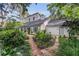 Charming home with manicured garden beds with a brick walkway framed by lush greenery and mature trees at 1315 E 24Th St, Sanford, FL 32771