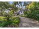 Well-maintained home with a long driveway surrounded by mature trees and lush landscaping at 1315 E 24Th St, Sanford, FL 32771