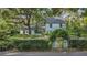 Charming two-story home with mature trees, lush landscaping, and a welcoming yellow front door at 1315 E 24Th St, Sanford, FL 32771
