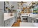 Inviting kitchen featuring a stainless steel refrigerator, stove, white countertops, and rustic tile floor at 1315 E 24Th St, Sanford, FL 32771