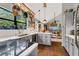 Open-concept kitchen featuring a breakfast bar, bright countertops, cabinets, and rustic tile floors at 1315 E 24Th St, Sanford, FL 32771