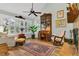 Inviting living room with vaulted ceiling, hardwood floors, and a cozy rocking chair near the fireplace at 1315 E 24Th St, Sanford, FL 32771