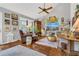 Cozy living room featuring unique decor, tile floors, a ceiling fan, and comfortable seating arrangements at 1315 E 24Th St, Sanford, FL 32771